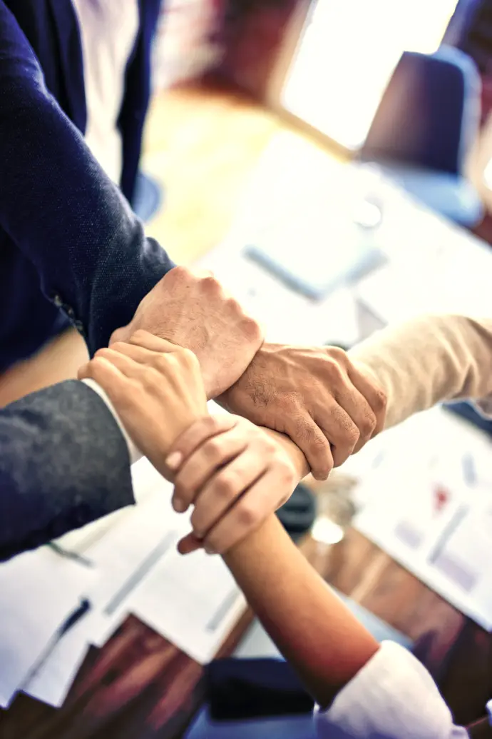 person in black long sleeve shirt holding persons hand